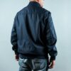 Man wearing a navy sports jacket from behind