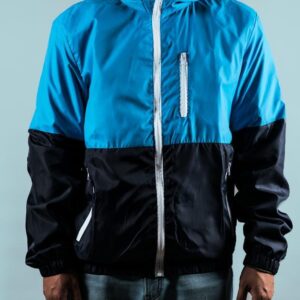 man wearing a half blue and half black zip up sport jacket