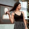 woman wearing striped skirt and black tank top